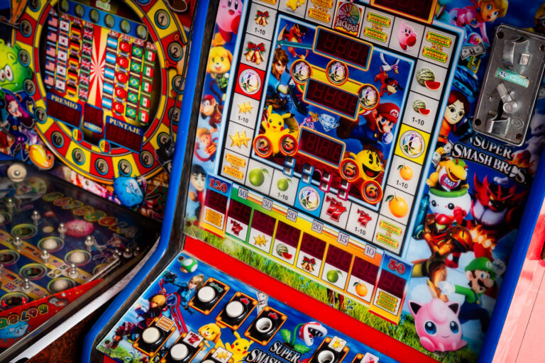 “Super Smash Bros” Slot Machine in Rural Mexico 4 An arcade-style slot machine featuring characters from Nintendo’s Super Smash Bros franchise sits in a small-town game room in rural Mexico. These hybrid machines blend bright pop culture imagery with traditional fruit slot mechanics, often appearing in corner stores or markets. The colorful display includes Mario, Pikachu, and Link—iconic figures reimagined for a local form of low-stakes entertainment that bridges nostalgia, informal gaming culture, and Mexico’s enduring fascination with coin-operated amusements.