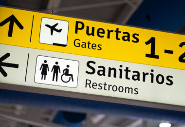 Restroom and gate signage at Puerto Vallarta International Airport.