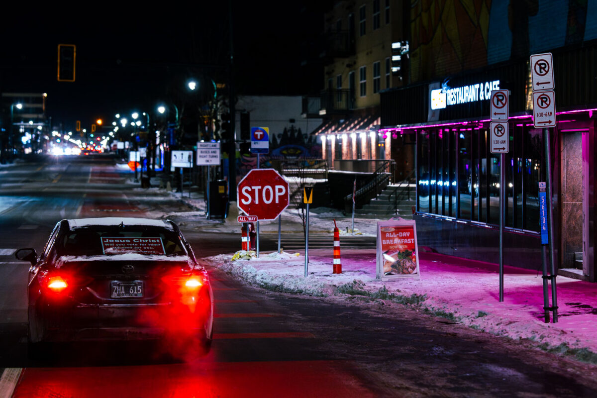 A car on Lake Street in Minneapolis with a sign reading "Jesus Christ. Will you vote for him?".