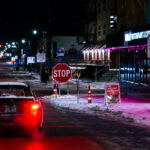 A car on Lake Street in Minneapolis with a sign reading "Jesus Christ. Will you vote for him?".