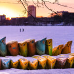 Canoes and kayaks stacked up in the snow around Bde Maka Ska.
