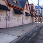 Graffiti on a long vacant building on Lyndale Avenue in South Minneapolis. It reads "Real patriots kill nazis"