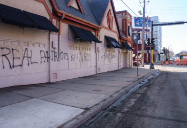 Graffiti on a long vacant building on Lyndale Avenue in South Minneapolis. It reads "Real patriots kill nazis"