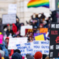 Protester at the Minnesota State Capitol on February 5, 2025 holding up a sign that reads "We defeated nazis once we can do it again".