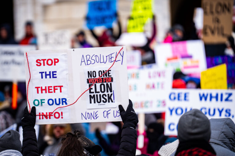 No one voted for Elon Musk! 1 Protester at the Minnesota State Capitol on February 5, 2025 holding up a sign that reads "Stop the theft of our info!" "Absolutely no one voted for elon musk! None of us!".