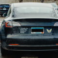 A Tesla vehicle seen in Minneapolis with Tesla branding removed and a sticker reading "I bought this before Elon became a fascist.".