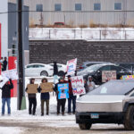 Protesters at the Tesla service center just outside of Minneapolis. Signs reading “Unplug Mad King Musk”, “This car runs on fascism”, “Who buys cars from a nazi?”, “Say no to doge”, “Don’t buy swasticars, BAD DOGE!”. Protest is part of a nationwide "TeslaTakedown" protest that seems to have originated on Bluesky.
