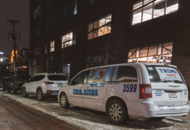 A taxi cab seen in the North Loop Minneapolis in February 2025. Windows covered in pictures of President Trump.