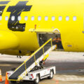 Baggage handler in Spirit Airlines plane at MSP Airport