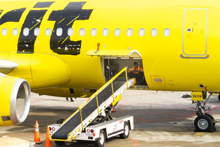 Baggage handler at MSP Airport 1 A baggage handler inside a Spirit Airlines plane at Minneapolis St. Paul Airport.