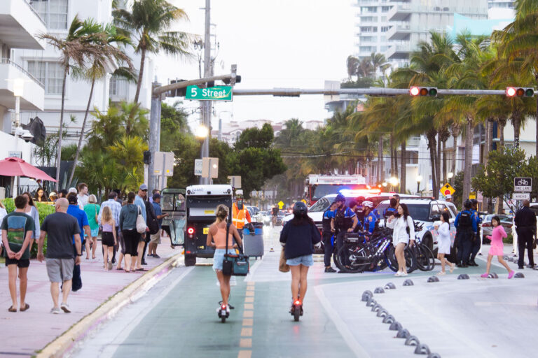 Bike Police during Spring Break in Miami Beach 2 Spring breakers on scooters head past a group of police officers in South Beach during 2025 Spring Break in Miami Beach.