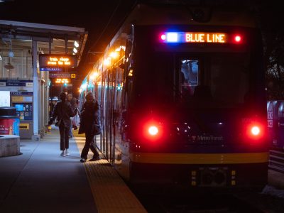 Riders Board a Blue Line Train at Cedar-Riverside Station