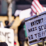 Protest sign reading:

"Boycott Nazi Scum No Tesla".

Protesters have gathered each Saturday for weeks now at this Tesla Facility just outside of Minneapolis (Golden Valley).