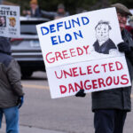 Defund Elon Greedy Unelected Dangerous protest sign in MN 1 About 500 protesters outside Tesla in Minneapolis (Golden Valley) with signs reading “NOT PAID JUST PISSED”, “Tesla Funds Fascists”, “Save the VA”, “No Vet Left Behind”, Make Nazis Afraid Again” to name a few. This is the 7th weekend in a row of protests at this showroom.