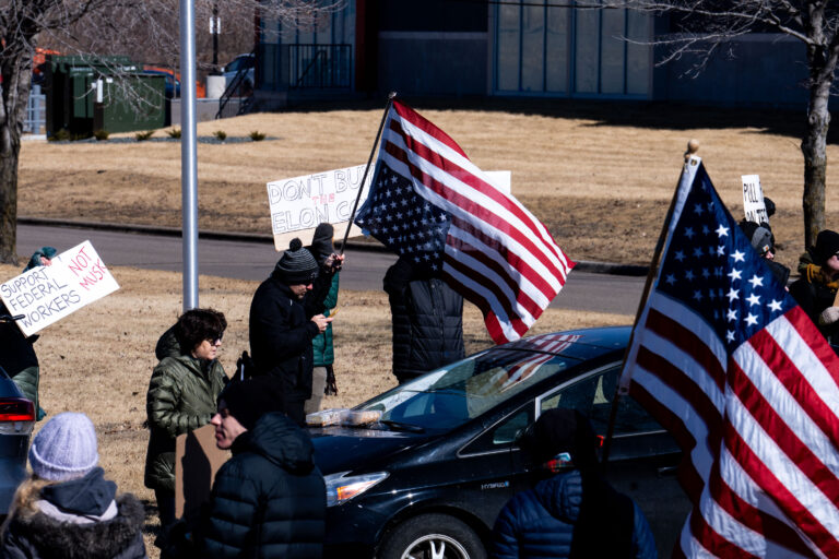 Dualing American Flags at Elon Musk Tesla Protest in Minneapolis 1 An upside down American Flag and a right side up American Flag seen outside a Tesla facility in Minneapolis (Golden Valley) on March 1, 2025. Protesters have been gathering for weeks now protesting the actions of Elon Musk and his Doge Department under the Trump administration.