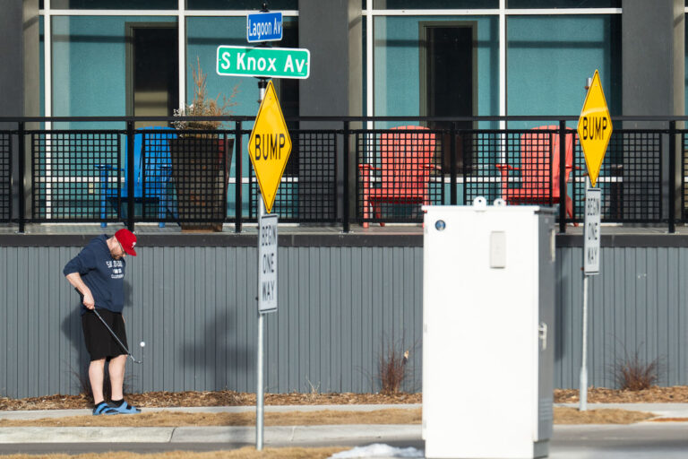 First 60 degree day of the year in Minneapolis 4 A man with a golf club and ball in Uptown Minneapolis on the first 60 degree day of the year.