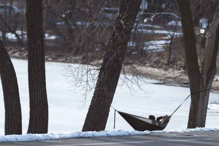 Hammocking on Bde Maka Ska Minneapolis 1 A couple in a hammock on the lake on the first 60 degree day of the year in Minneapolis.