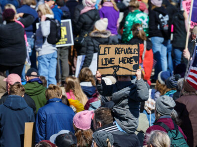 Let refugees live here protest sign