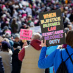 Protest sign in Minnesota March 8 2025 2 "When Justice Becomes Law Resistance Becomes Duty" protest sign in St. Paul.Today on International Women’s Day, Minnesota saw the largest protest since President Trump's re-election. 1,000+ gathered at the Capitol for the 2nd time this week hearing from activists, city council members and state representatives on the current administration's actions.Minnesota State CapitolMarch 8, 2025