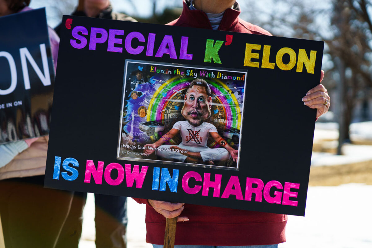 Protester holding a sign that reads "Special K Elon Is Now In Charge" at a Tesla Facility just outside of Minneapolis (Golden Valley) on March 8, 2025.

This is the 4th week in a row protesters have gathered here as part of the nationwide Tesla Takedown organizing.