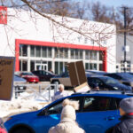 Stop Funding Musk Don't Buy Tesla 1 Protesters hold up signs outside a Tesla Facility just outside of Minneapolis (Golden Valley) on March 8, 2025.This is the 4th week in a row protesters have gathered here as part of the nationwide Tesla Takedown organizing.