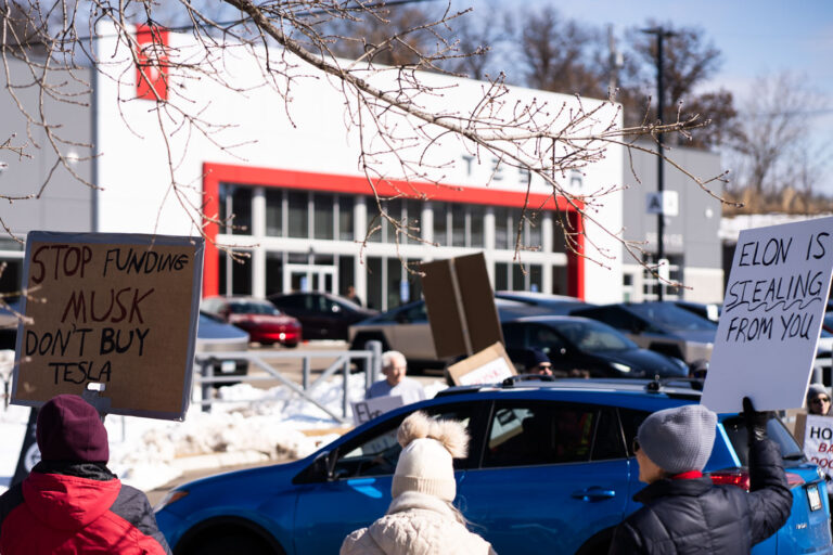 Stop Funding Musk Don't Buy Tesla 1 Protesters hold up signs outside a Tesla Facility just outside of Minneapolis (Golden Valley) on March 8, 2025.This is the 4th week in a row protesters have gathered here as part of the nationwide Tesla Takedown organizing.