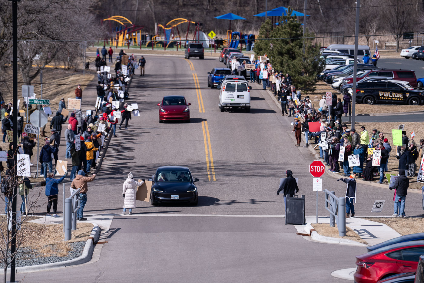 Tesla car drives past protesters in Minneapolis March 2025