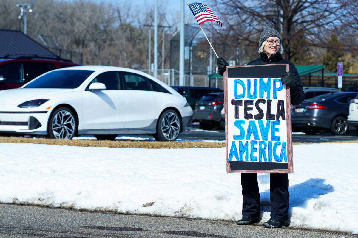 Protester holds a sign that reads "Dump Tesla Save America". Seen at a Tesla facility just outside of Minneapolis (Golden Valley) on March 8, 2025.

This is the 4th week in a row protesters have gathered here as part of the nationwide Tesla Takedown organizing.