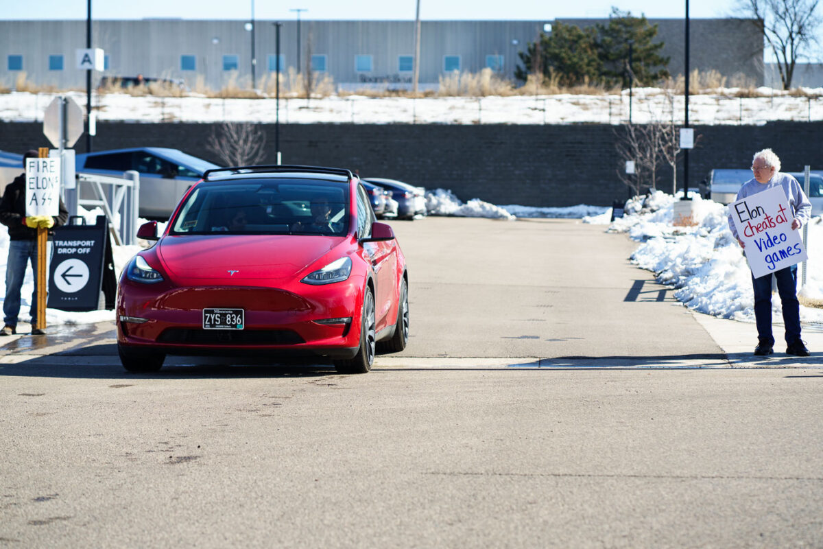 Tesla vehicle leaves a Tesla Facility just outside of Minneapolis (Golden Valley) on March 8, 2025.

This is the 4th week in a row protesters have gathered here as part of the nationwide Tesla Takedown organizing.