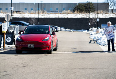 Tesla vehicle leaves a Tesla Facility just outside of Minneapolis (Golden Valley) on March 8, 2025.

This is the 4th week in a row protesters have gathered here as part of the nationwide Tesla Takedown organizing.