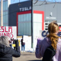 Protesters hold signs outside a Tesla showroom in Golden Valley(Minneapolis) on March 8,2025.