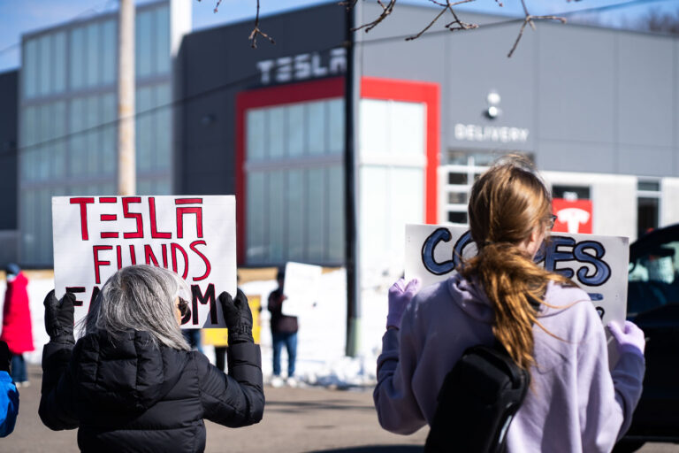 Tesla Takedown Protest Sign Tesla Funds Fascism Minnesota 4 Protesters hold signs outside a Tesla showroom in Golden Valley(Minneapolis) on March 8,2025.