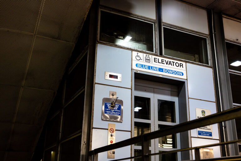 Bowdoin Station Elevator, Blue Line 1 An elevator entrance at Bowdoin station, the downtown terminal of Boston’s Blue Line. Bowdoin Station opened in 1916 as part of the East Boston Tunnel, one of the earliest underwater rapid-transit tunnels in North America. The station is notable for its compact footprint, tight curves, and historically limited accessibility compared to newer MBTA stations.
This elevator provides step-free access between street level and the platform, reflecting later retrofits required by accessibility standards rather than original station design. The utilitarian signage, metal paneling, and enclosed structure are characteristic of mid-to-late 20th century upgrades layered onto early 20th century transit infrastructure, illustrating how legacy subway systems have been incrementally adapted to modern accessibility and safety requirements.