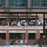 A full rooftop patio at Cowboy Jack's in downtown Minneapolis on a warm spring day.
