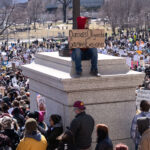 Hands Off Protesters in St. Paul Minnesota 3 "Dumbass Oligarchs Gouging Everyone" protest sign. The Minnesota State Patrol estimates 25,000 gathered at the Minnesota State Capitol this afternoon as part of the nationwide “Hands Off!” protests.