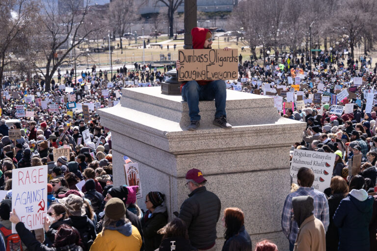 Hands Off Protesters in St. Paul Minnesota 3 "Dumbass Oligarchs Gouging Everyone" protest sign. The Minnesota State Patrol estimates 25,000 gathered at the Minnesota State Capitol this afternoon as part of the nationwide “Hands Off!” protests.
