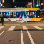 A light rail train moves towards the Warehouse District/Hennepin Ave station on a warm spring evening.