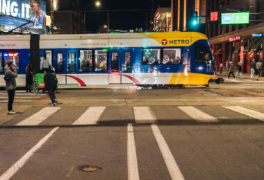 A light rail train moves towards the Warehouse District/Hennepin Ave station on a warm spring evening.