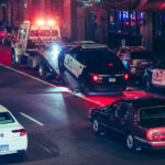 A Minneapolis Police squad car is towed off Lagoon Ave in Uptown Minneapolis in April 2025.