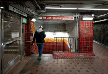 Inside Park Street station, one of the oldest active subway stations in the United States. Opened in 1897 as part of the Tremont Street Subway, the station has long served as a central transfer point beneath Boston Common. The tiled corridors and low ceilings reflect early subway construction techniques, with later renovations layering modern lighting, signage, and safety systems onto the original structure. Directional signage for the Ashmont and Braintree branches marks this passage as part of the MBTA Red Line, which continues to use Park Street as a key junction between downtown Boston and the city’s southern neighborhoods.