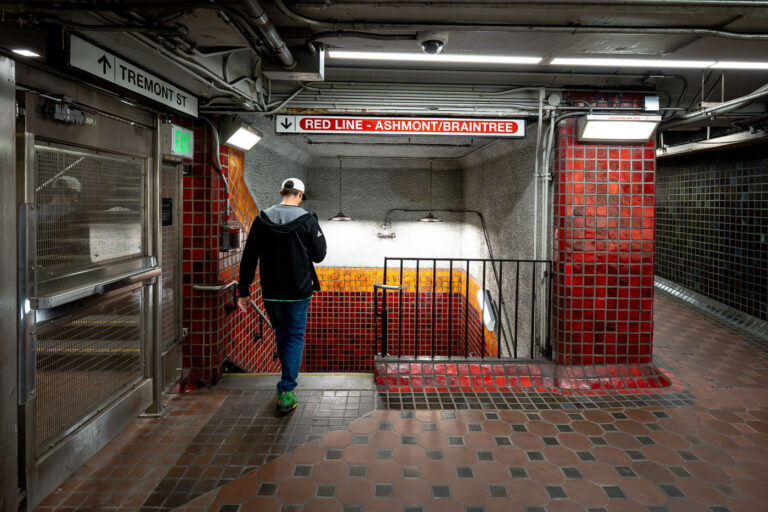 Park Street Station Red Line Passage 3 Inside Park Street station, one of the oldest active subway stations in the United States. Opened in 1897 as part of the Tremont Street Subway, the station has long served as a central transfer point beneath Boston Common. The tiled corridors and low ceilings reflect early subway construction techniques, with later renovations layering modern lighting, signage, and safety systems onto the original structure. Directional signage for the Ashmont and Braintree branches marks this passage as part of the MBTA Red Line, which continues to use Park Street as a key junction between downtown Boston and the city’s southern neighborhoods.