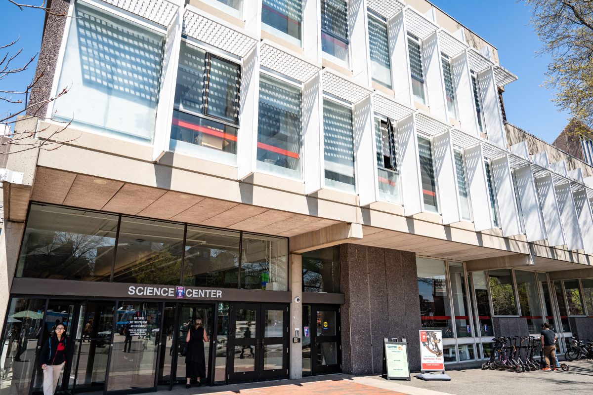 Harvard Science Center building entrance with modernist white facade and ground-level storefront.