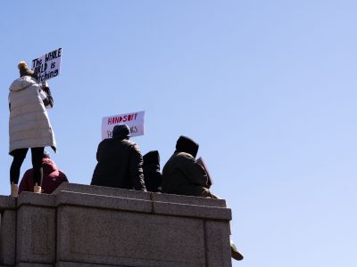 Protesters Perched on a Ledge at the Hands Off Rally in St. Paul