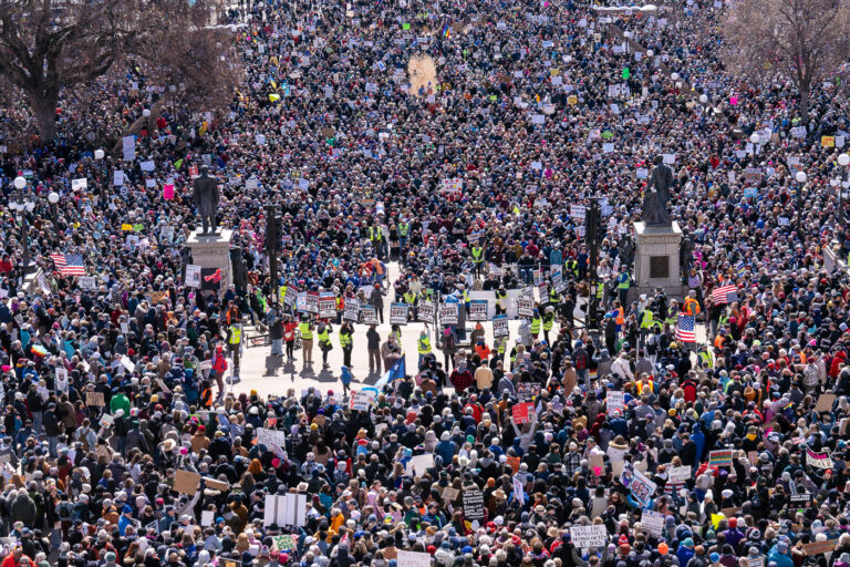 Hands Off Minnesota State Capitol crowd of thousands 2 Hands Off! protest signs in St. Paul.The Minnesota State Patrol estimates 25,000 gathered at the Minnesota State Capitol this afternoon as part of the nationwide “Hands Off!” protests.
