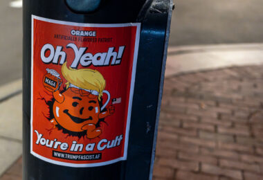 Poster on a pole at Harvard University.

You're in a Cult" in the form of the Kool-Aid man with a link that redirects to The Council on Foreign Relations's definition of fascism.