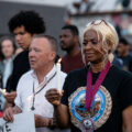 Angela Harrelson, George Floyd's aunt and co-chair of Rise and Remember, with a candle during a vigil on the 5th anniversary of George Floyd's murder.