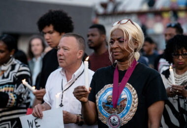 Angela Harrelson, George Floyd's aunt and co-chair of Rise and Remember, with a candle during a vigil on the 5th anniversary of George Floyd's murder.