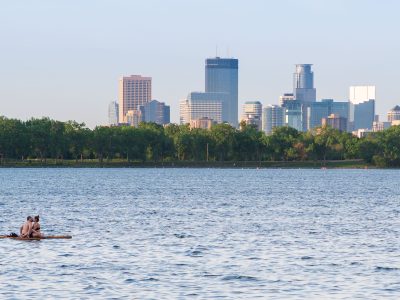 Couple Floating on Bde Maka Ska, Minneapolis Skyline