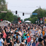 Fist at 38trh and Chicago on 5th anniversary 4 Candlelight vigil walks down Chicago Avenue away from the first towards Say Their Names Cemetery. The vigil happens each year on the 5th anniversary of George Floyd's murder.