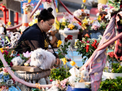 Minneapolis George Floyd Memorial: Woman lays flower, 5th Anniv.
